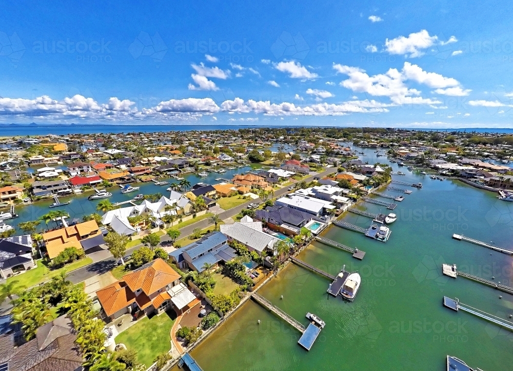 Aerial drone uav footage over waterfront properties with private jetties and solar panels in Newport - Australian Stock Image
