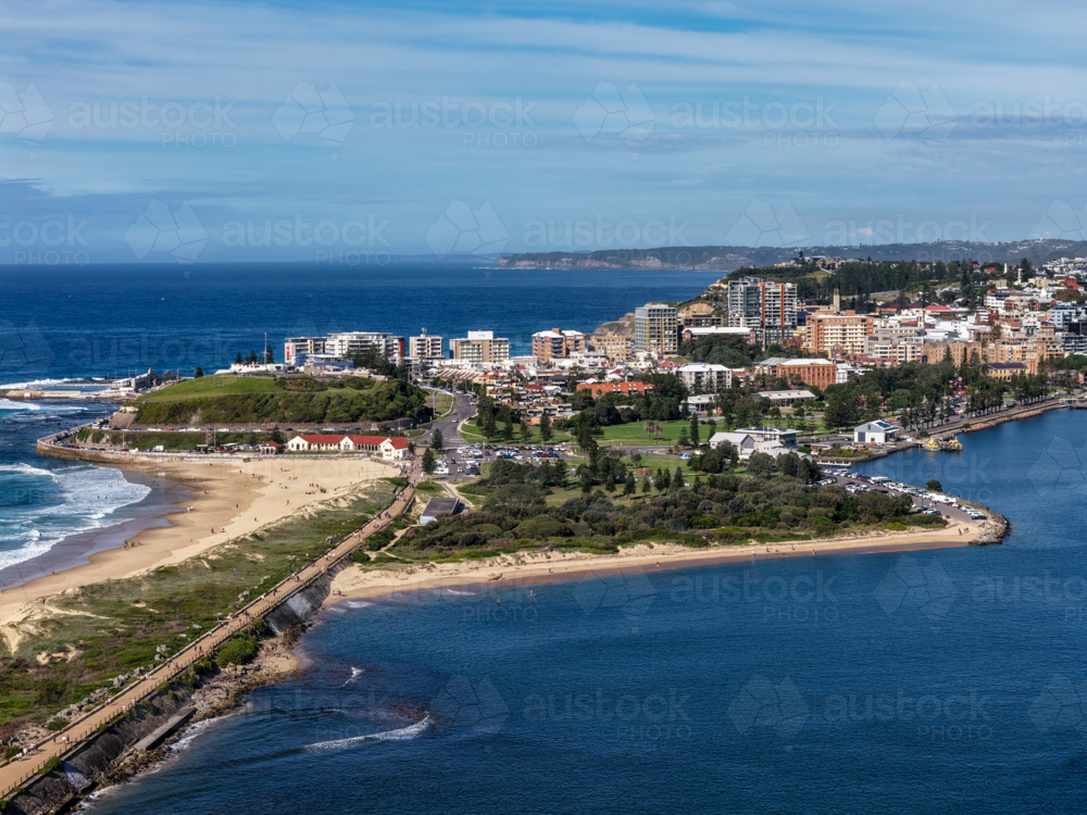 Aerial drone view of Horseshoe Beach and Nobbys Beach with Newcastle city skyline in the background. - Australian Stock Image