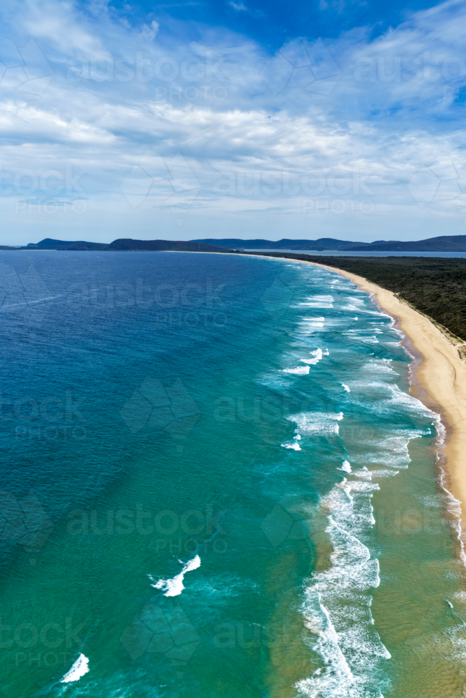 Aerial drone view of Seven Mile Beach in Forster showcasing a long stretch of sandy shoreline. - Australian Stock Image