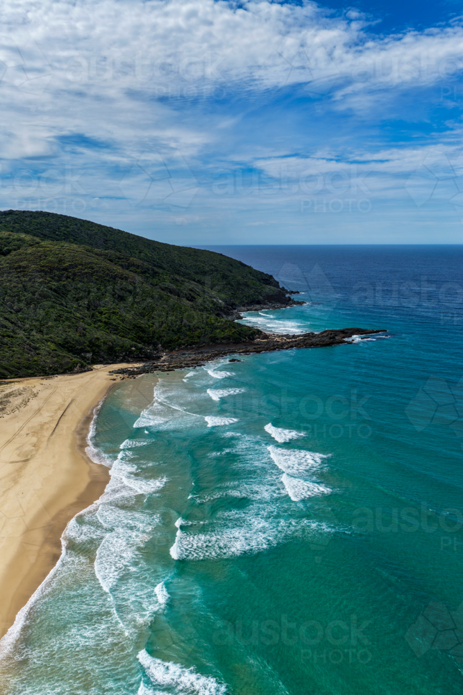 Aerial drone view of Seven Mile Beach in Forster showcasing a long stretch of sandy shoreline. - Australian Stock Image