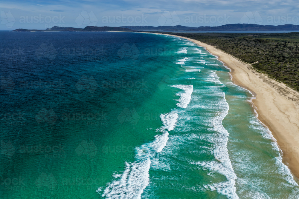Aerial drone view of Seven Mile Beach in Forster showcasing a long stretch of sandy shoreline. - Australian Stock Image