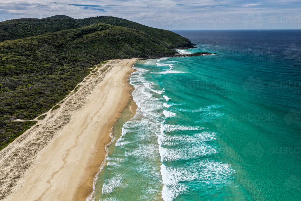 Aerial drone view of Seven Mile Beach in Forster showcasing a long stretch of sandy shoreline. - Australian Stock Image