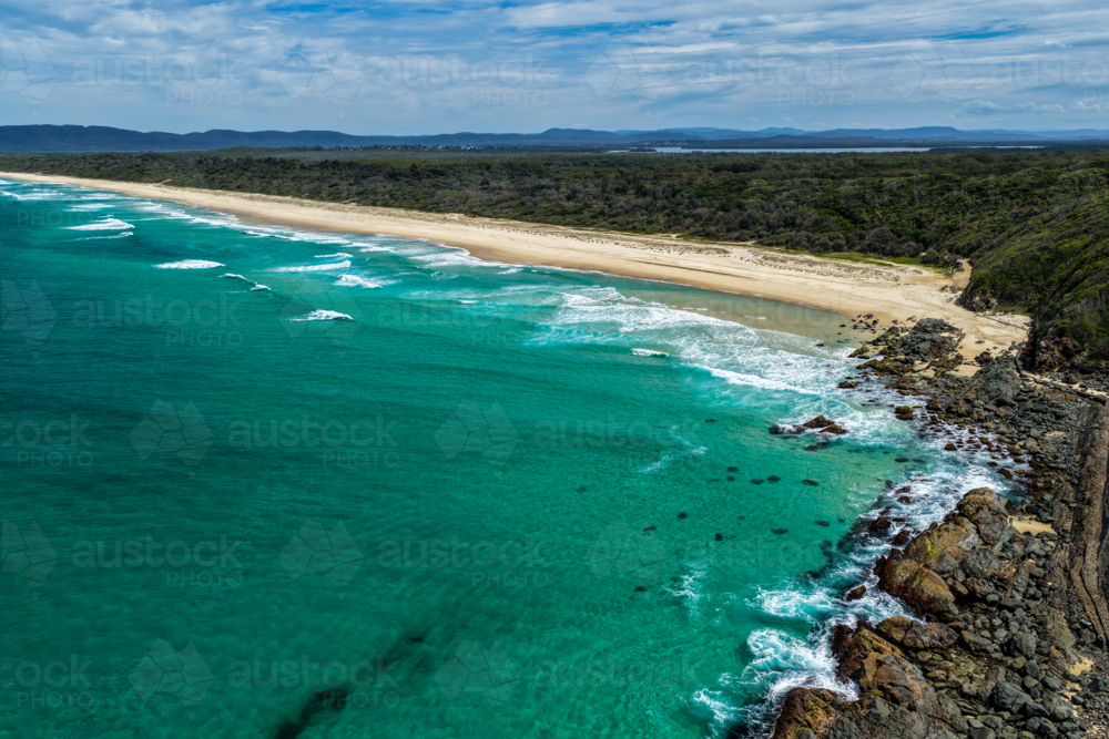 Aerial drone view of Seven Mile Beach in Forster showcasing a long stretch of sandy shoreline. - Australian Stock Image