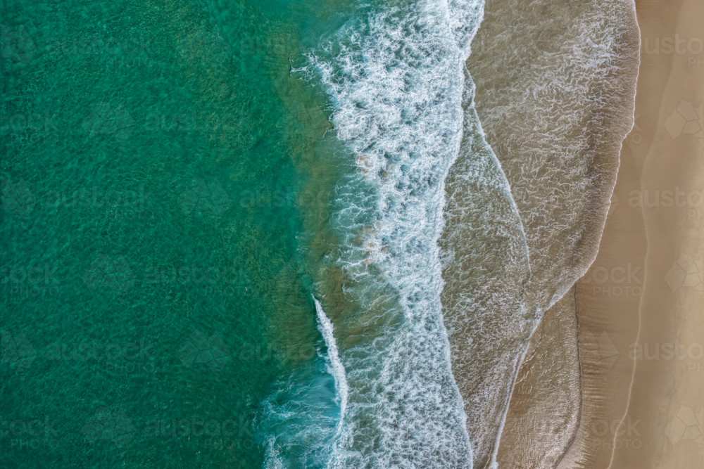 Aerial drone view of Seven Mile Beach in Forster showing waves rolling onto a sandy shoreline. - Australian Stock Image
