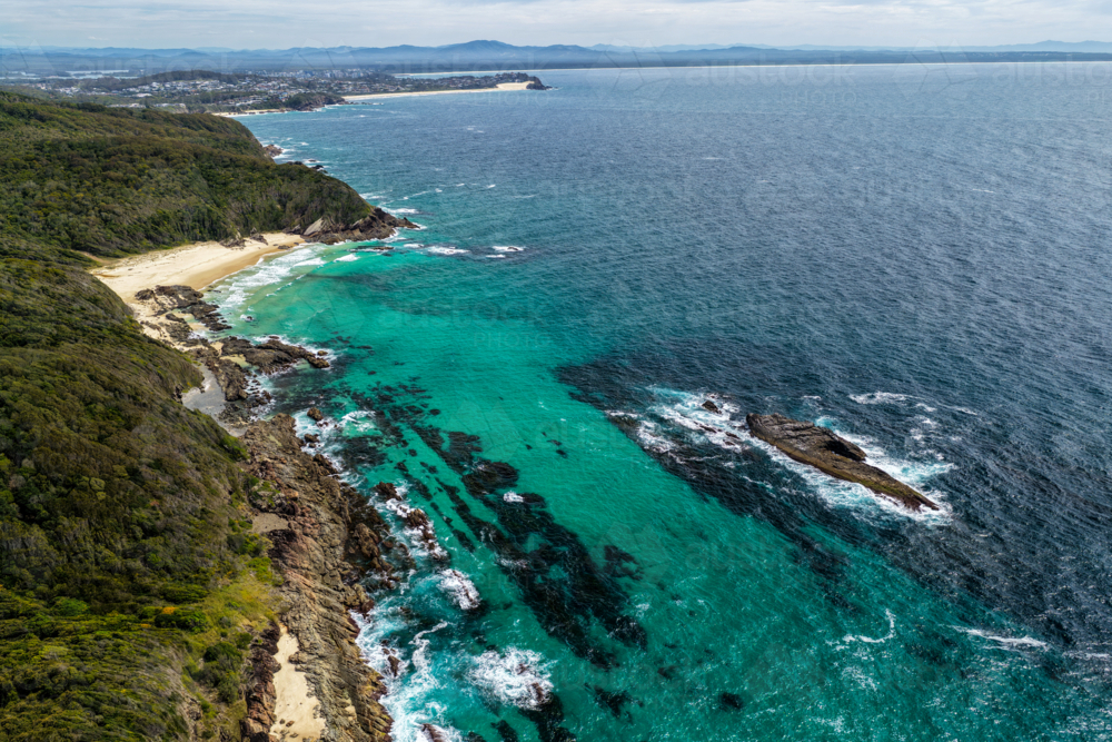 Aerial drone view over McBrides Beach showing the surrounding coastal landscape. - Australian Stock Image