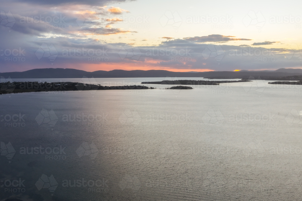Aerial drone view over Pipers Bay in Forster, New South Wales, Australia with cloudy sky. - Australian Stock Image