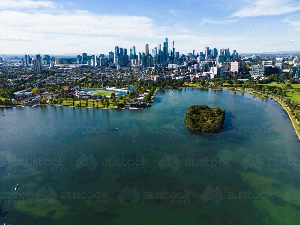 Aerial image above Albert Park Lake looking towards the Melbourne city centre - Australian Stock Image