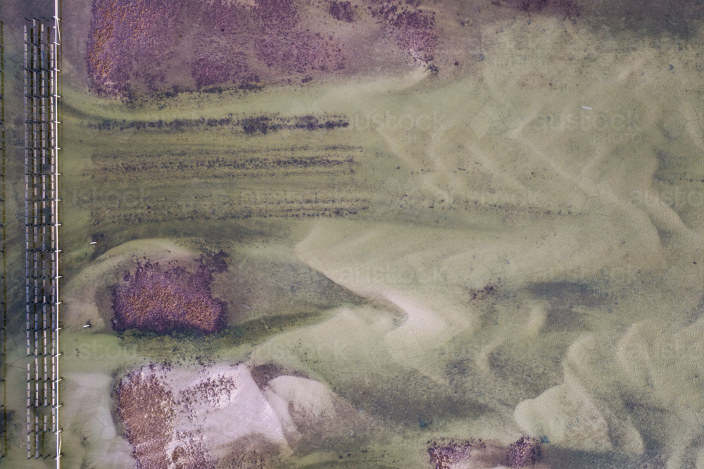 Aerial image capturing a river in Tuncurry at low tide, revealing intricate natural patterns - Australian Stock Image