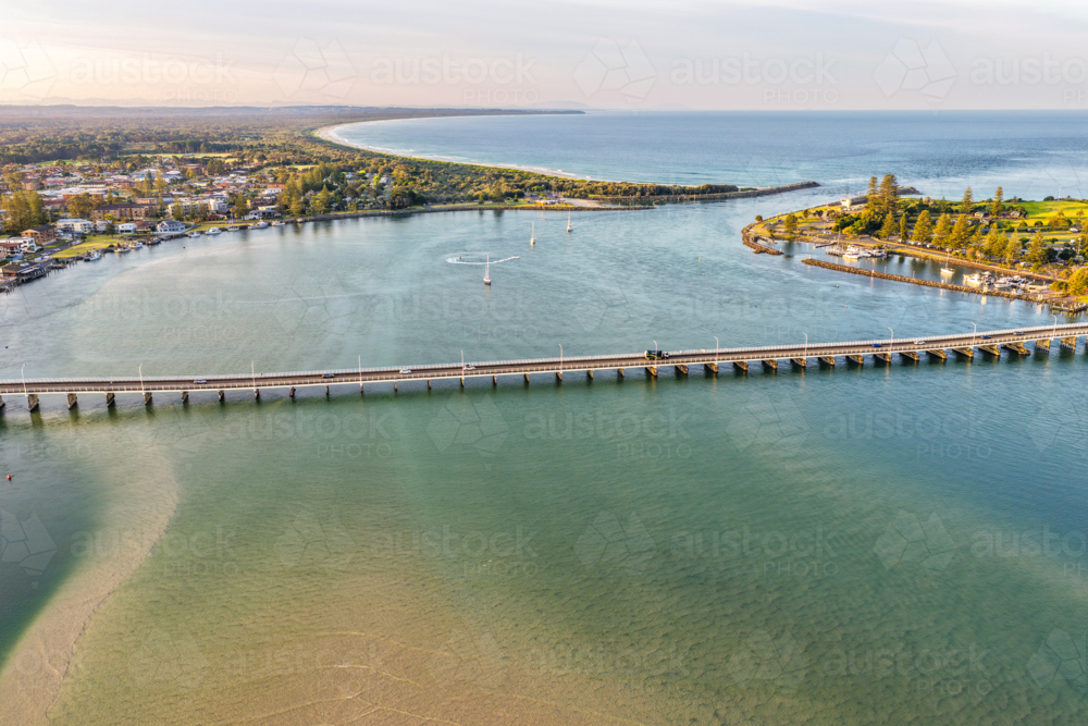 Aerial image capturing the calm blue waters of Wallis Lake with the Tuncurry Forster Bridge - Australian Stock Image