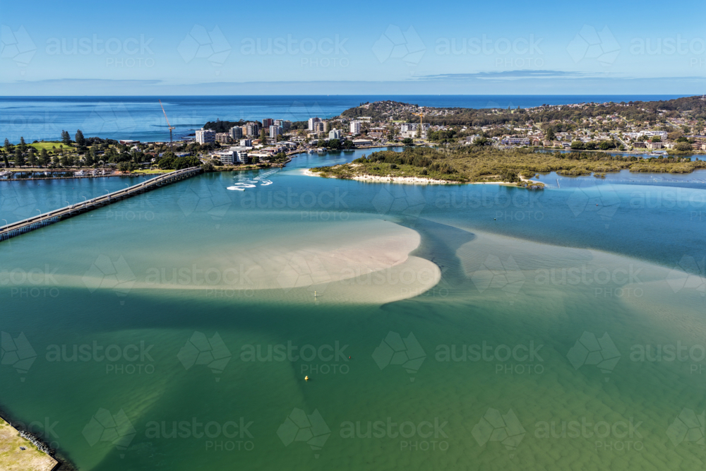 Aerial image capturing the calm blue waters of Wallis Lake with the Tuncurry Forster Bridge - Australian Stock Image