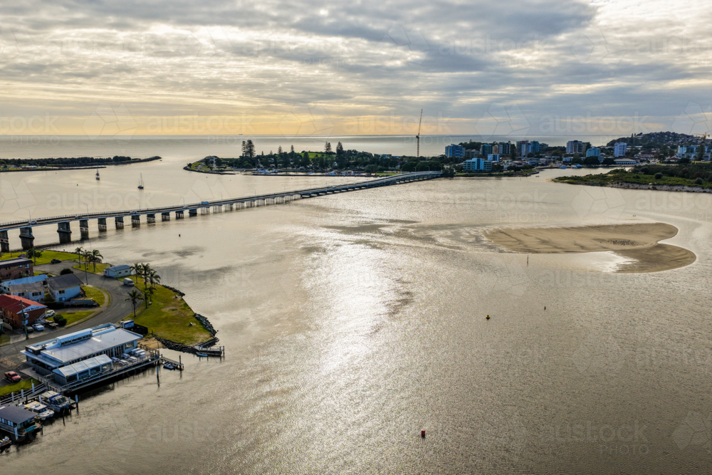 Aerial image capturing the calm waters of Wallis Lake with the Tuncurry Forster Bridge - Australian Stock Image
