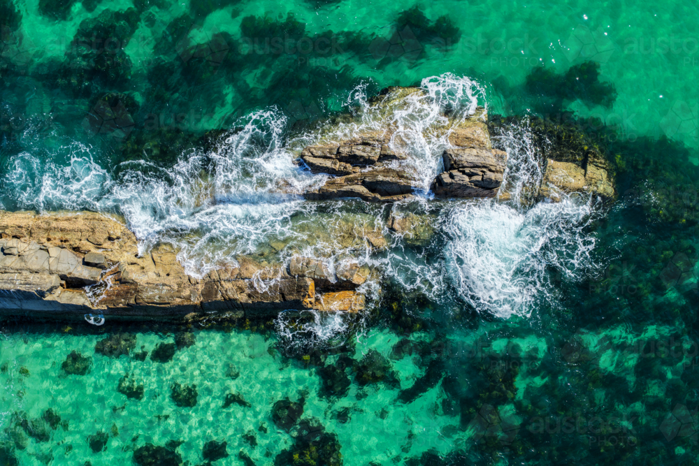 Aerial image capturing the rugged rock pools and turquoise water at The Tanks in Forster - Australian Stock Image