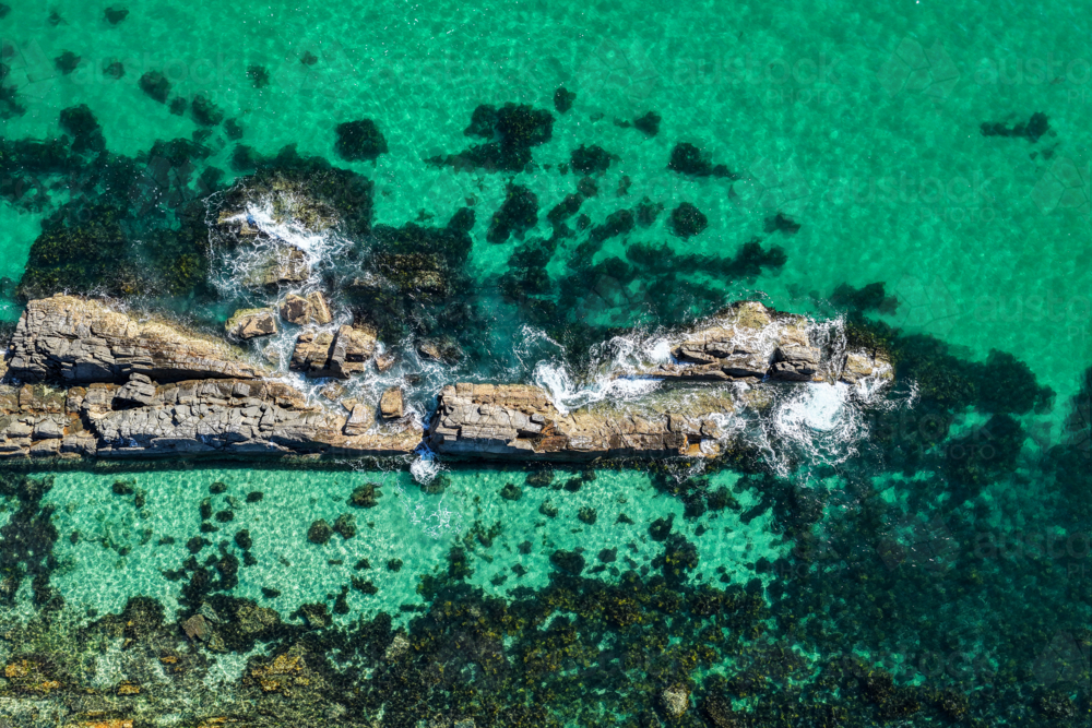 Aerial image capturing the rugged rock pools and turquoise water at The Tanks in Forster - Australian Stock Image