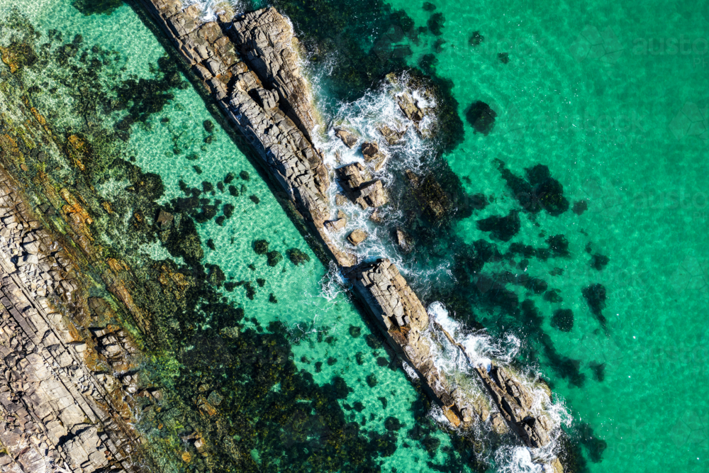 Aerial image capturing the rugged rock pools and turquoise water at The Tanks in Forster - Australian Stock Image