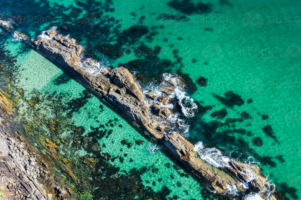 Aerial image capturing the rugged rock pools and turquoise water at The Tanks in Forster - Australian Stock Image