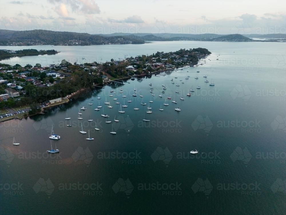 Aerial image looking south from Gosford at boats moored in Brisbane Water at dusk - Australian Stock Image