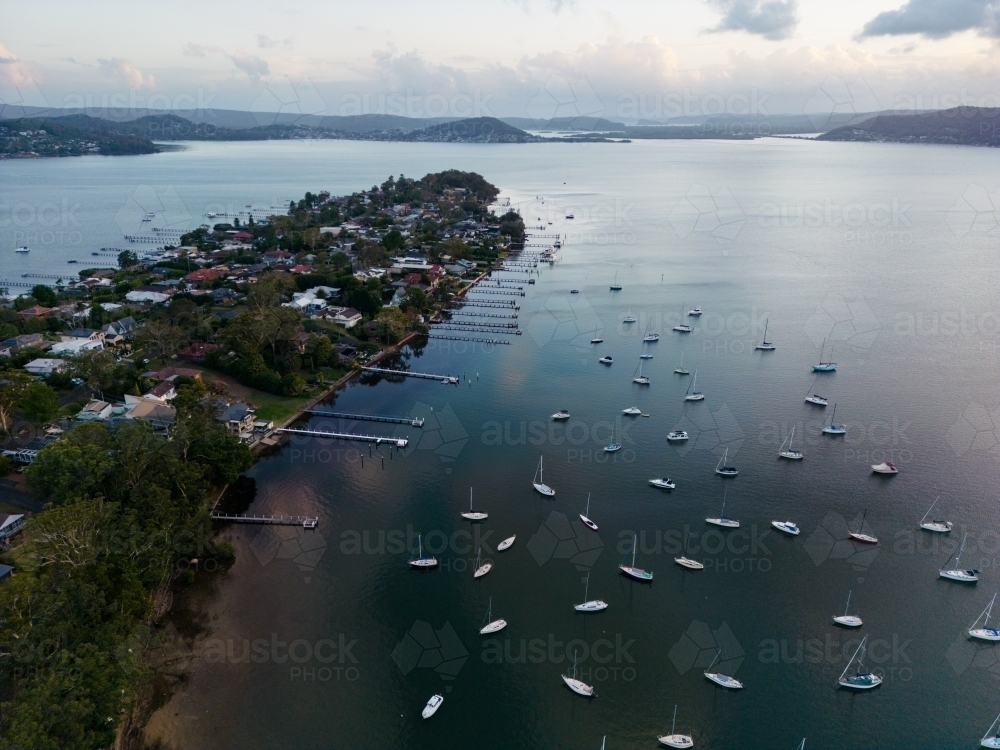 Aerial image looking south from Gosford at boats moored in Brisbane Water at dusk - Australian Stock Image