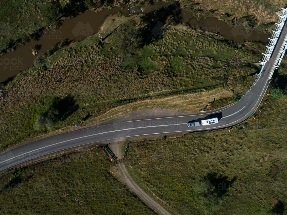 aerial image of car pulling caravan on road in Glendonbrook on sunlit day - Australian Stock Image