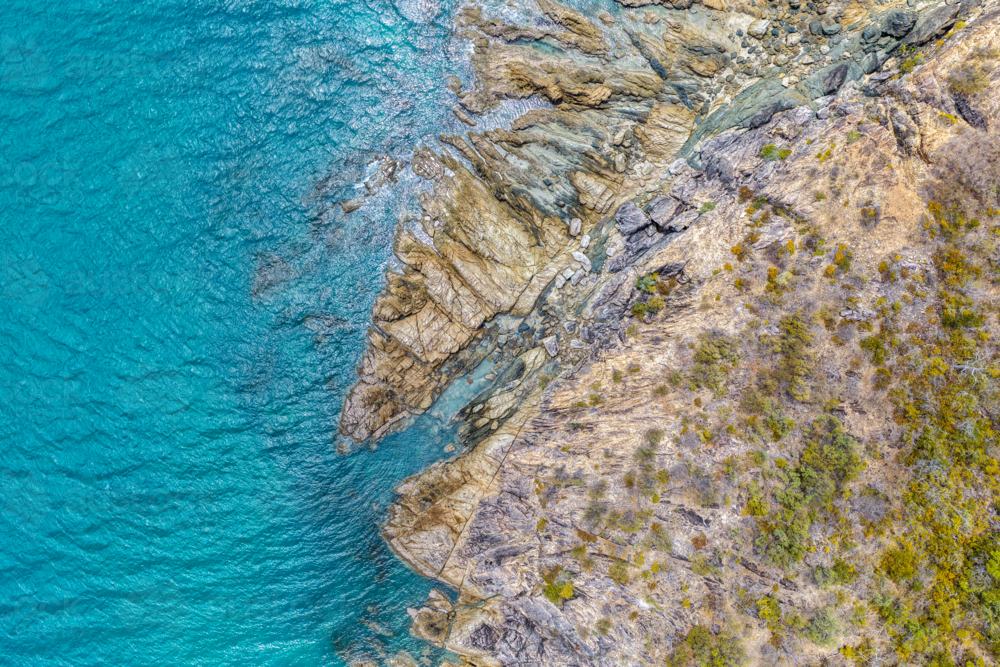 Aerial image of Hydeaway Bay, capturing its brilliant turquoise water, rocky headlands - Australian Stock Image