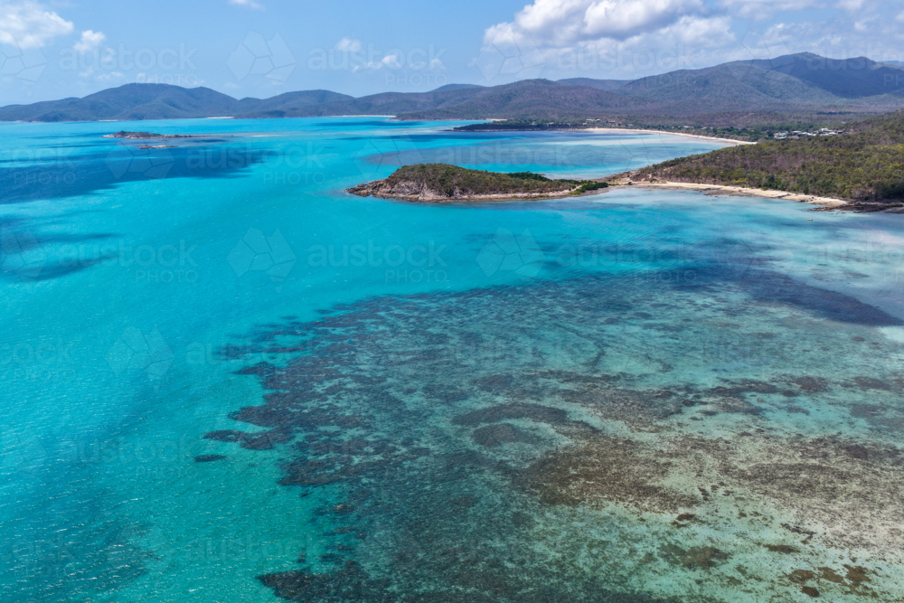 Aerial image of Hydeaway Bay, capturing its brilliant turquoise water, rocky headlands - Australian Stock Image