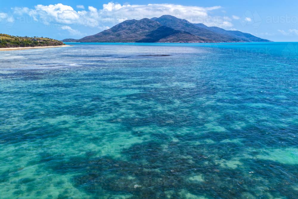 Aerial image of Hydeaway Bay, capturing its brilliant turquoise water, rocky headlands - Australian Stock Image