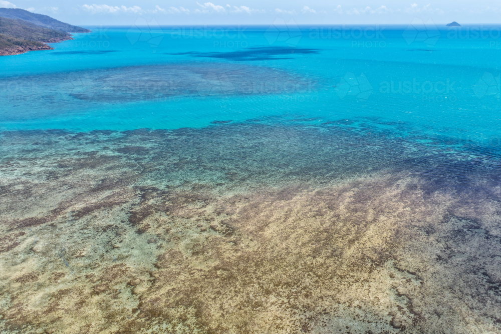 Aerial image of Hydeaway Bay, capturing its brilliant turquoise water, rocky headlands - Australian Stock Image