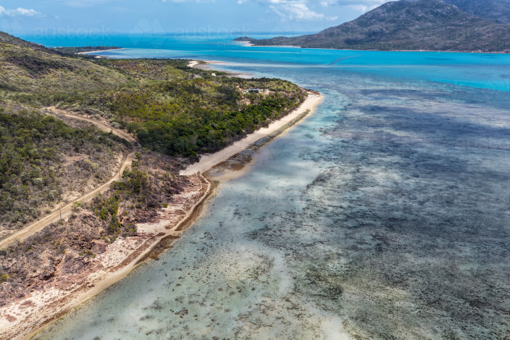 Aerial image of Hydeaway Bay, capturing its brilliant turquoise water, rocky headlands - Australian Stock Image