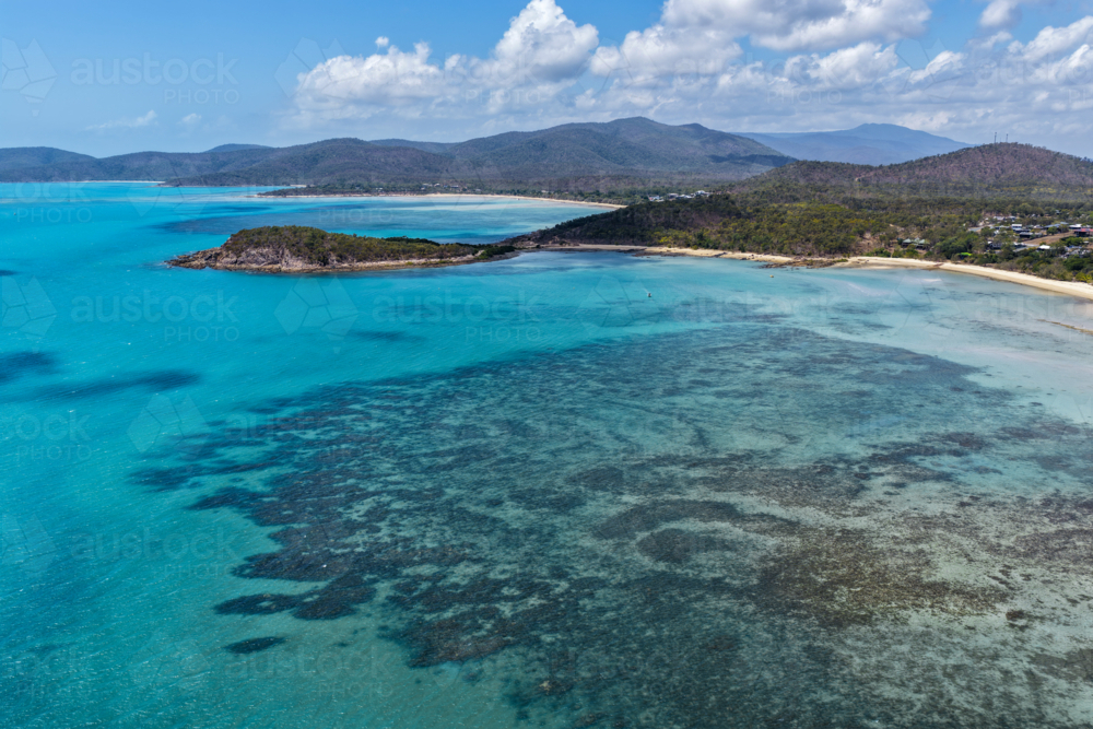 Aerial image of Hydeaway Bay, capturing its brilliant turquoise water, rocky headlands - Australian Stock Image