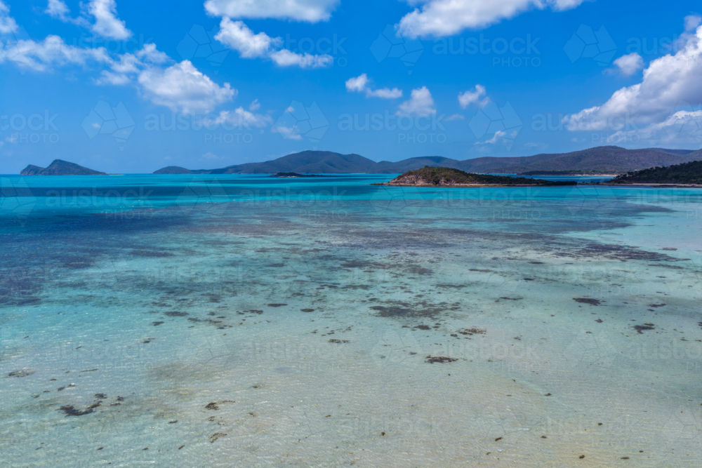Aerial image of Hydeaway Bay, capturing its brilliant turquoise water, rocky headlands - Australian Stock Image