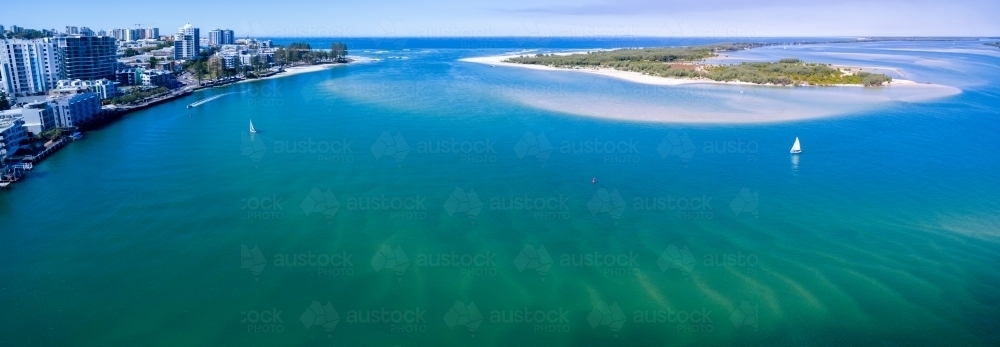 Aerial image of two small sailboats sailing over rippled sandbars. - Australian Stock Image