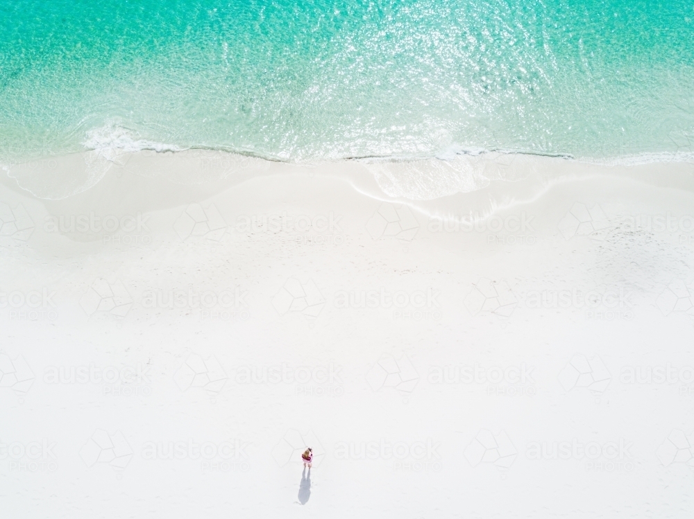 Aerial image of woman on idyllic perfect beach - Australian Stock Image