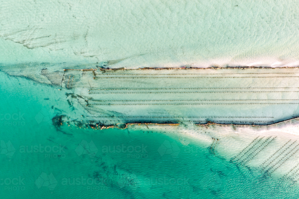 Aerial image showcasing the bright turquoise waters of Wallis Lake at low tide with patterns in sand - Australian Stock Image