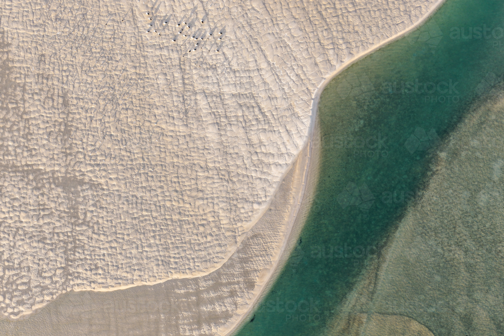 Aerial image showcasing the bright turquoise waters of Wallis Lake at low tide with patterns in sand - Australian Stock Image