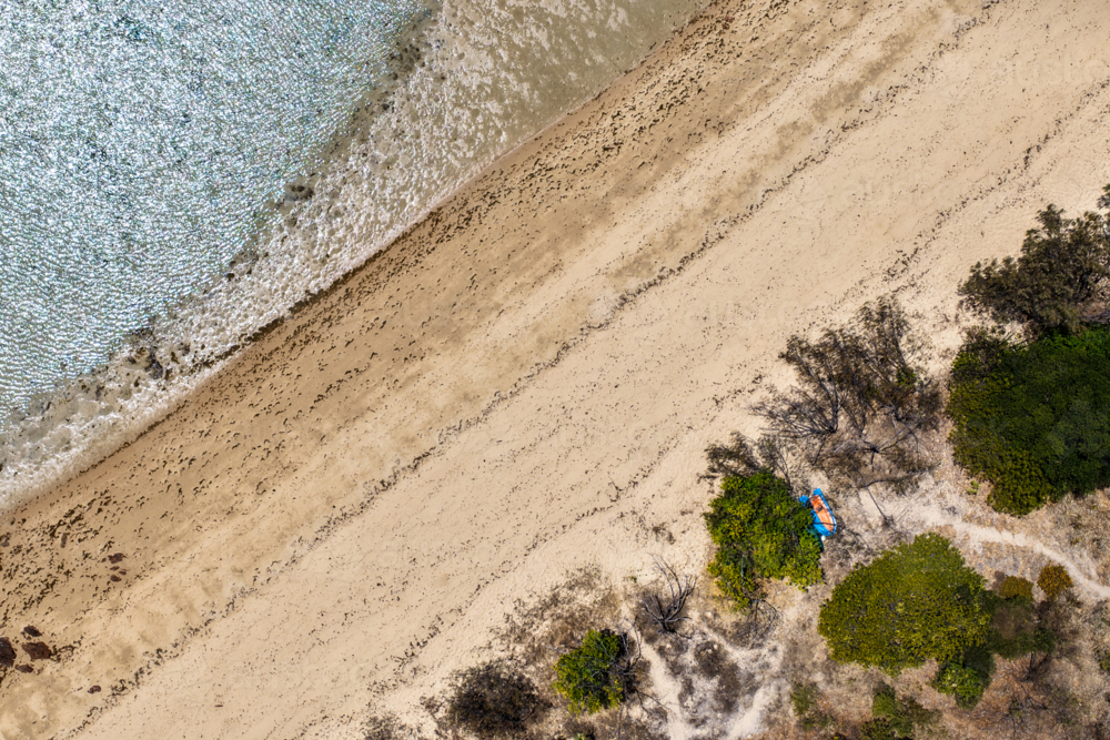 Aerial image showcasing the ocean, sandy shoreline, vegetation of Hydeaway Bay - Australian Stock Image