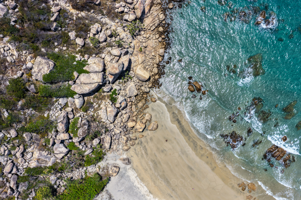 Aerial image showcasing the rugged rocky coastline of Rose Bay in Bowen - Australian Stock Image