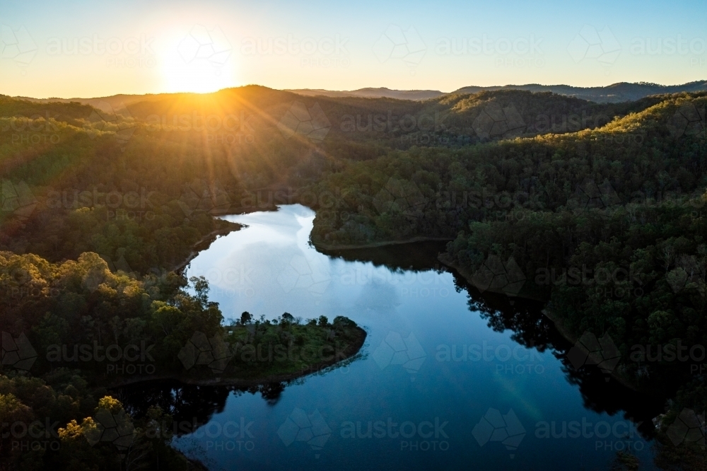 Aerial landscape of a lake surrounded by forest - Australian Stock Image