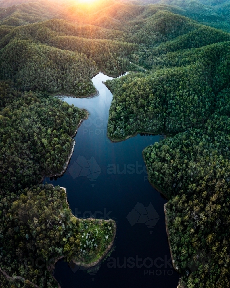Aerial landscape of a lake surrounded by forest - Australian Stock Image