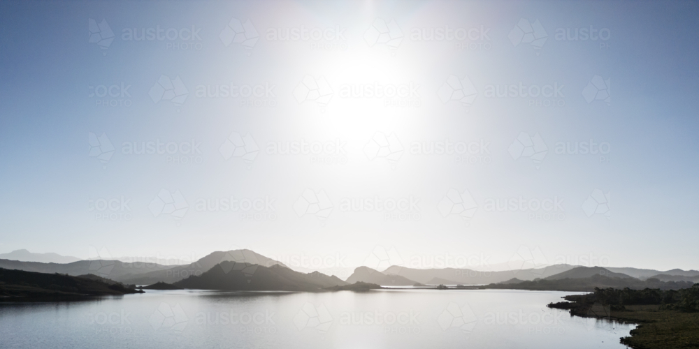 Aerial landscape of Lake Pedder on a hot summer's afternoon in Southwest National Park, Tasmania - Australian Stock Image