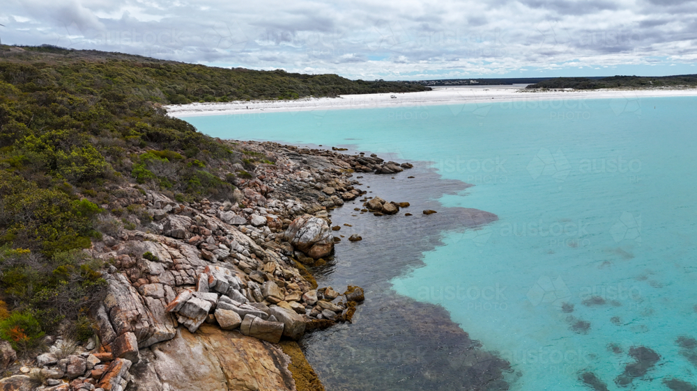 Aerial looking back at aesthetic beach with crystal water and white sand - Australian Stock Image