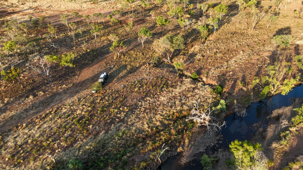 Aerial of caravan camped up by a river - Australian Stock Image