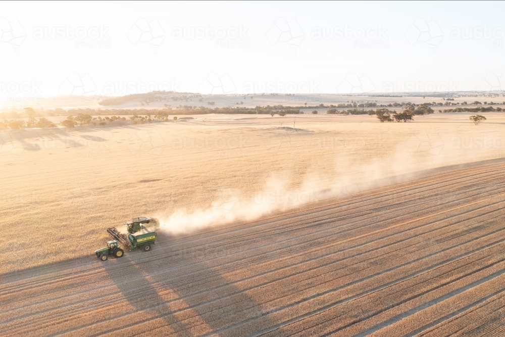 Aerial of header and chaser bin harvesting - Australian Stock Image