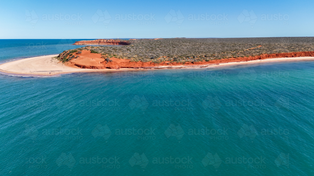 Aerial of red cliff point meeting the ocean - Australian Stock Image