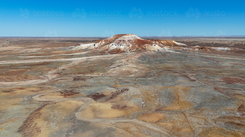 Aerial of remote painted desert hill - Australian Stock Image
