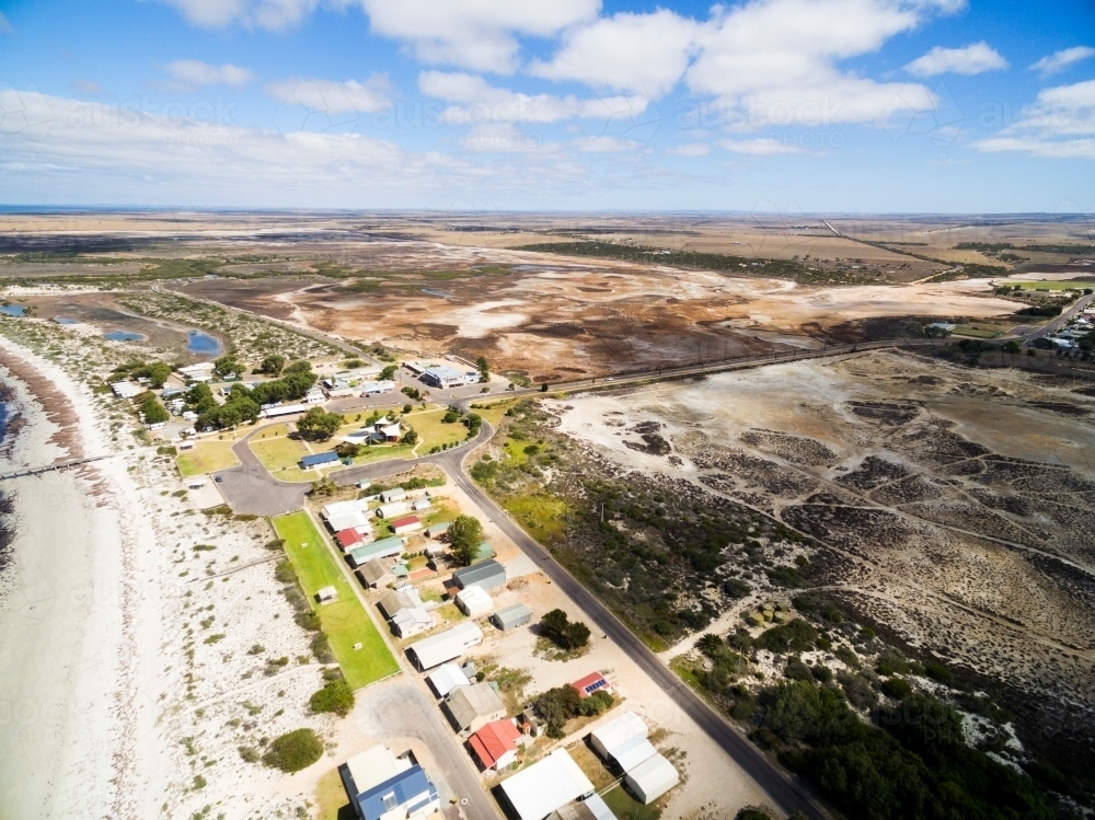 Aerial of seaside shacks and beach - Australian Stock Image
