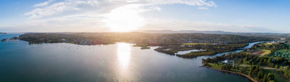 Aerial panorama of Cockle bay, five islands and Speers Point in Lake Macquarie as the sun sets - Australian Stock Image
