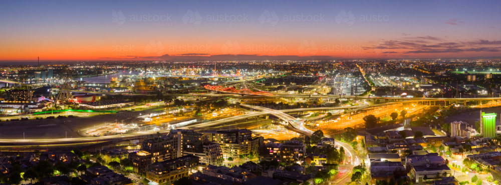 Aerial panorama view city lights at twilight over freeways and surrounding suburbs - Australian Stock Image