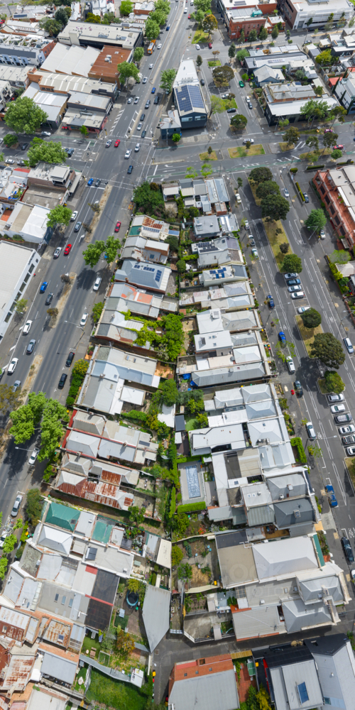 Aerial panorama view of suburban housing on a triangular city block bordered by busy roads - Australian Stock Image