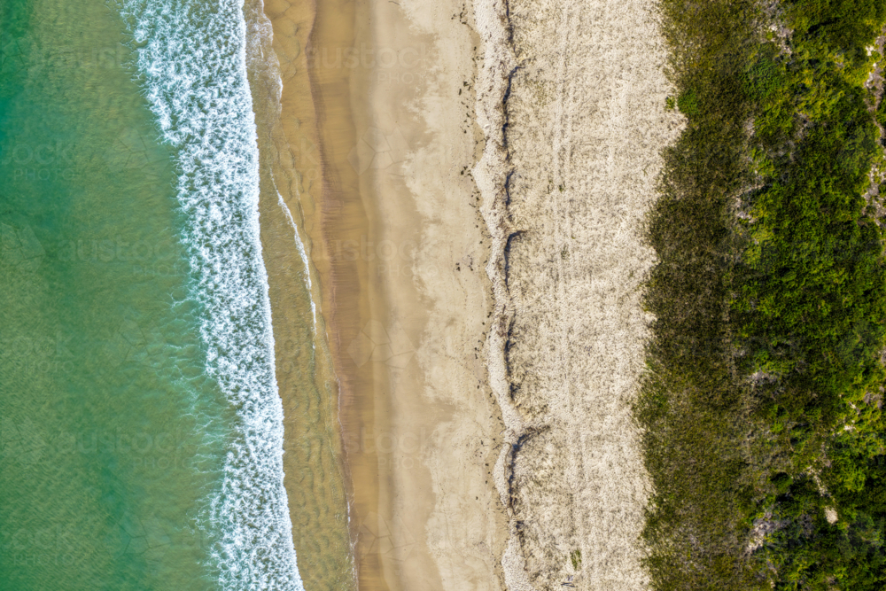 Aerial photo capturing Tuncurry Beach with its golden sand meeting turquoise waters - Australian Stock Image
