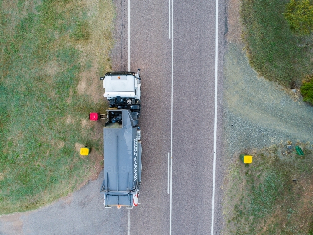 Aerial photo of garbage truck emptying bins in rural location - Australian Stock Image