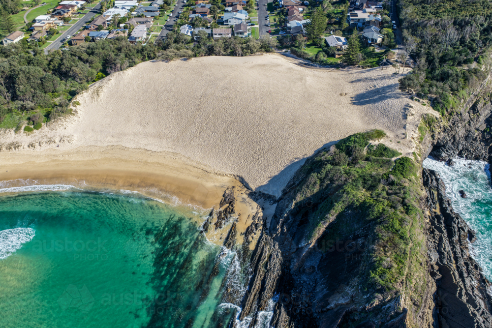 Aerial scene capturing Bennetts Head and the prominent sand dune overlooking One Mile Beach. - Australian Stock Image